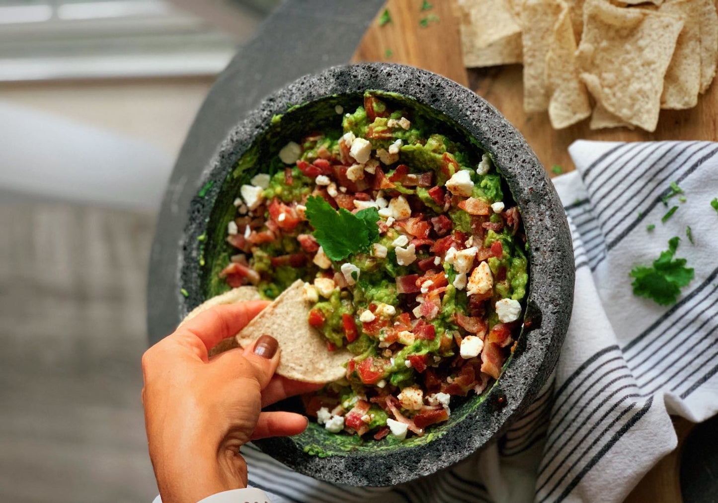 Guacamole with bacon, goat cheese, and maple-chipotle drizzle