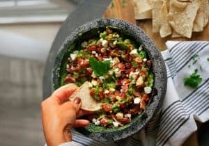 Guacamole with goat cheese, bacon, and maple-chipotle drizzle